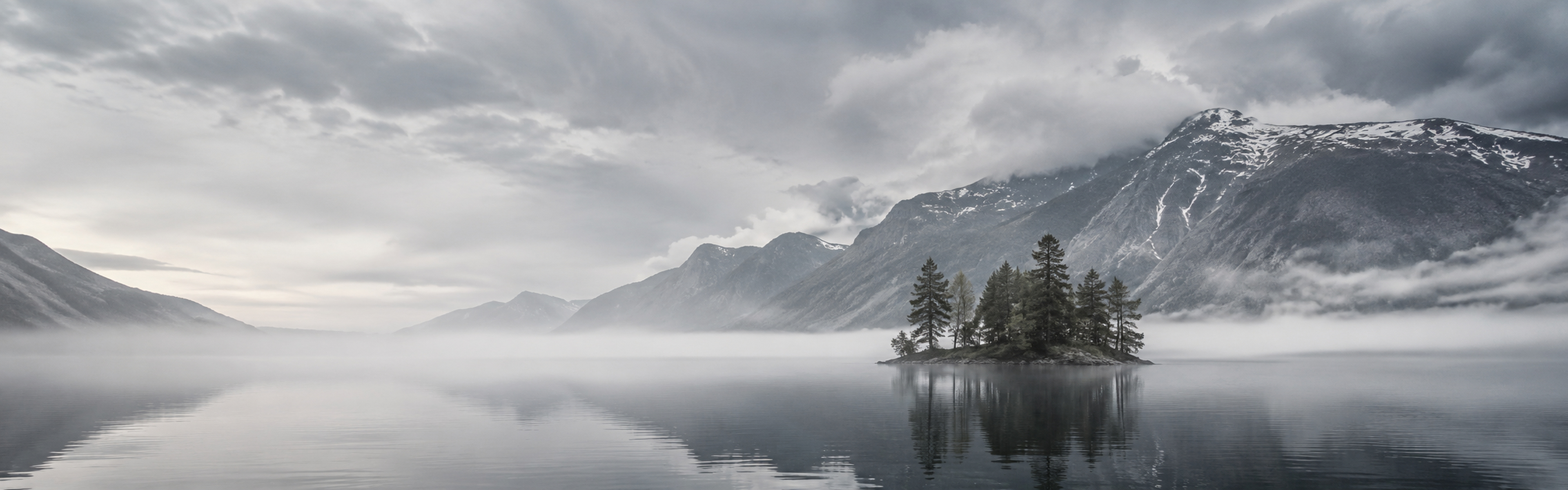 Quiet Nordic mountain lake with mist and forest shoreline